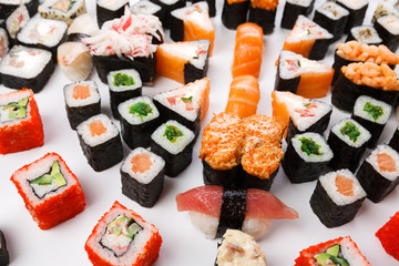 Set of sushi, maki and rolls isolated closeup with chopsticks