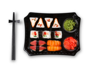 Set of sushi maki and rolls closeup in delivery box isolated at white