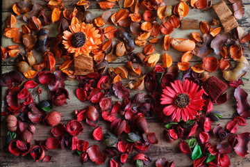 Background Orange and red petals and wooden plate