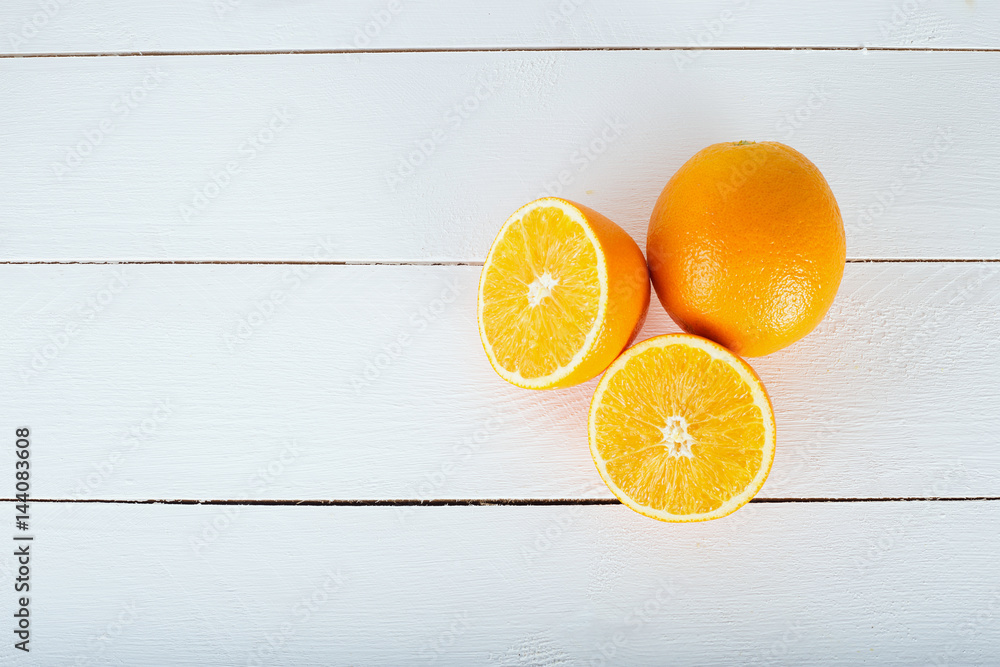 Wall mural fresh oranges on white wooden background. selective focus. wellness setting. health concept.