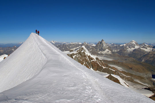 Mountaineers climbing sharpened ridg on Lyskamm (western), Aosta Valley, Italy, Europe