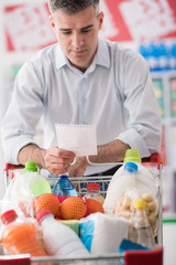 Man shopping with a grocery list