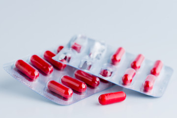 Pile of scattered capsules on a white background