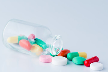 Medicine pills macro poured from a jar