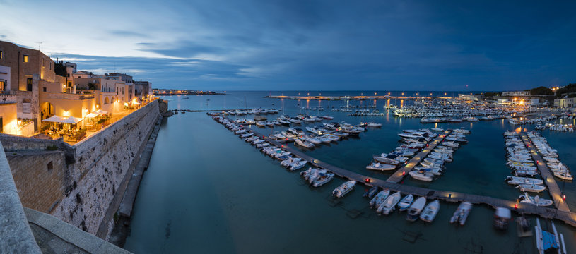 Dusk lights the harbor and the medieval old town of Otranto, Province of Lecce, Apulia