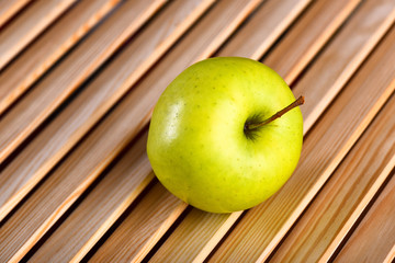 fresh green apple on brown wooden background