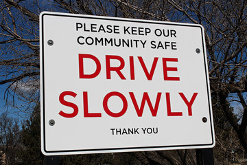 Fototapeta premium Drive slowly sign in a community area
