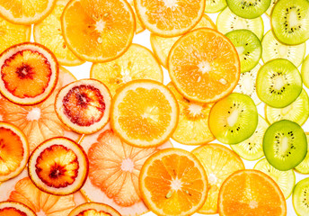 Mix of fresh transparent citrus fruits on white
