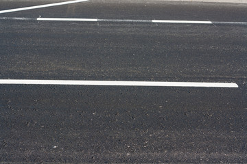 Asphalt road. White traffic on the road surface in Thailand.