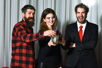 Happy friends smiling and clinking glasses with cocktails and alcohol