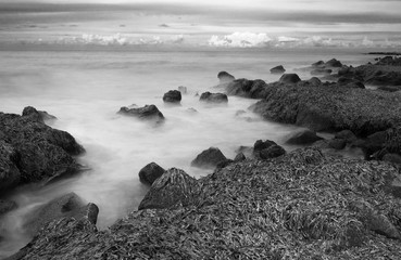 A long exposure photo of a rocky beach along the coast of Sicily, Italy.