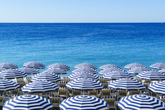 Blue and white beach parasols, Nice, Alpes Maritimes, Cote d'Azur, Provence, France, Mediterranean