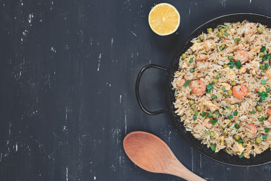 Fried rice with shrimp on the dark background