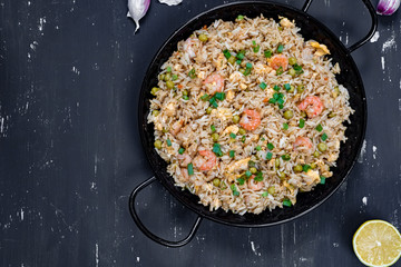 Fried rice with shrimp on the dark background