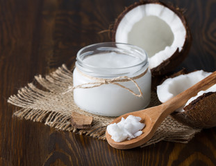 Coconut oil and fresh coconut on wooden table - 144090059