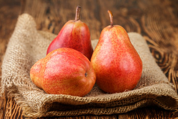 Ripe juicy organic red pears on the wooden table. Selective focus