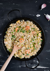 Fried rice with shrimp on the dark background
