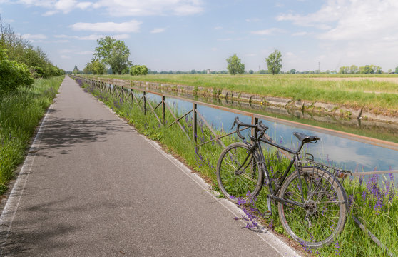 A bike on the rail of the Naviglio Pavense canal which links Milan to Pavia which has been transformed into a cycling path, Lombardy