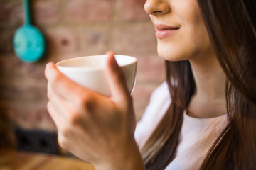 Close up of a woman hands holding a hot coffee cup in cafe shop