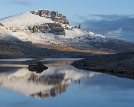 The Storr reflected in the calm waters of Loch Fada on a winter morning, Isle of Skye, Inner Hebrides, Scotland
