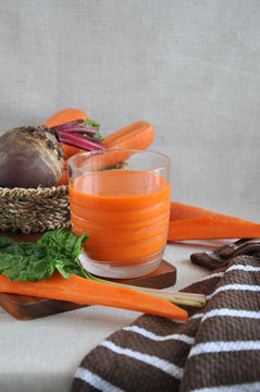 Fresh Carrot Juice on Wooden Board