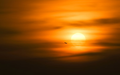 wild shot of silhouette Airplane with sunset in background