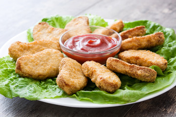Fried chicken nuggets on wooden table
