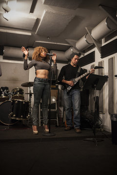 Musicians rehearsing in a recording studio