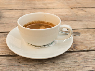 White Cup with a Double Espresso on a Wooden Table