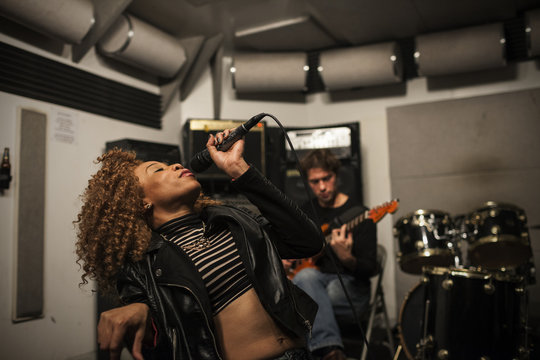 Musicians rehearsing in a recording studio