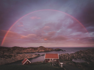 full rainbow and cabin