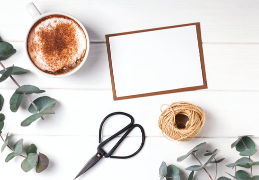 Blank paper, coffee and eucalyptus branches.