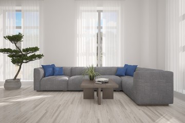 Fototapeta premium White room with sofa and green landscape in window. Scandinavian interior design. 3D illustration
