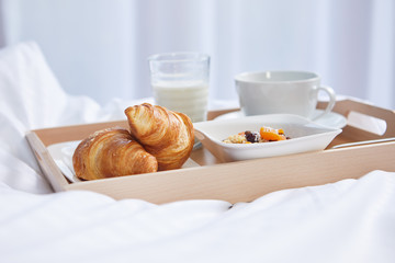 breakfast in bed with coffee and croissants