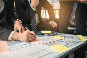 Young man discussing market research with colleagues in a meeting. Marketing Team Meeting Brainstorming Research Concept.