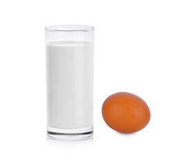 Glass of milk and egg isolated on white