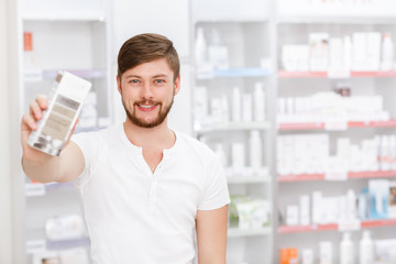 Cheerful customer shopping at the local pharmacy