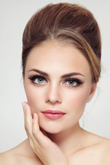 Young beautiful stylish girl with hair bun and cat eye make-up