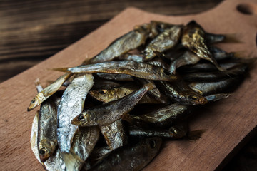 smoked sprats on wooden background