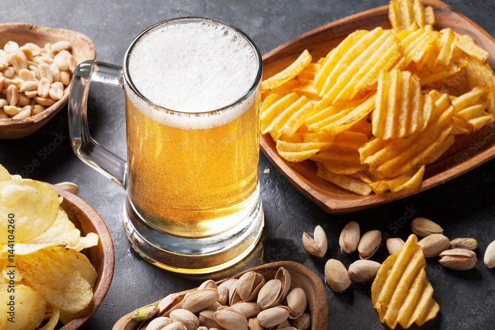 Wall mural lager beer and snacks on stone table