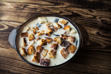 bowl of white soup with croutons