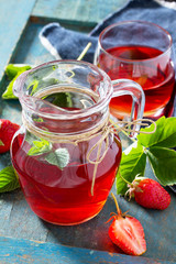 Strawberry juice on vintage blue background. The concept of eating vegetarians and fresh vitamins.