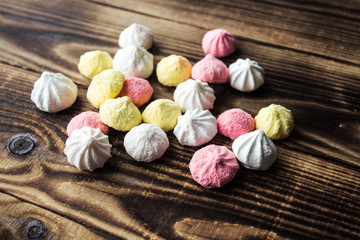 color candy meringue on wooden background