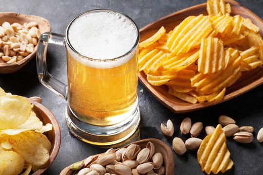 Lager Beer And Snacks On Stone Table