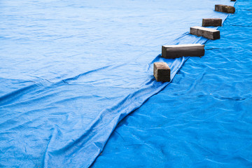 Blue industrial mesh textile with wooben planks