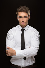 Handsome businessman on black background