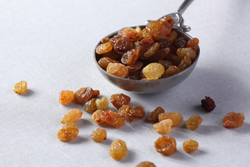 raisins  in steel spoon