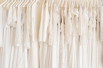 Many wedding dresses in atelier. Background