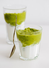 Green vegetarian Smoothie with Antioxidants, granola, kiwi, avocado strawberry for breakfast or lunch on white background. Healthy-woman food concept