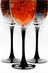 Yellow amber stones inside a transparent glass for wine.